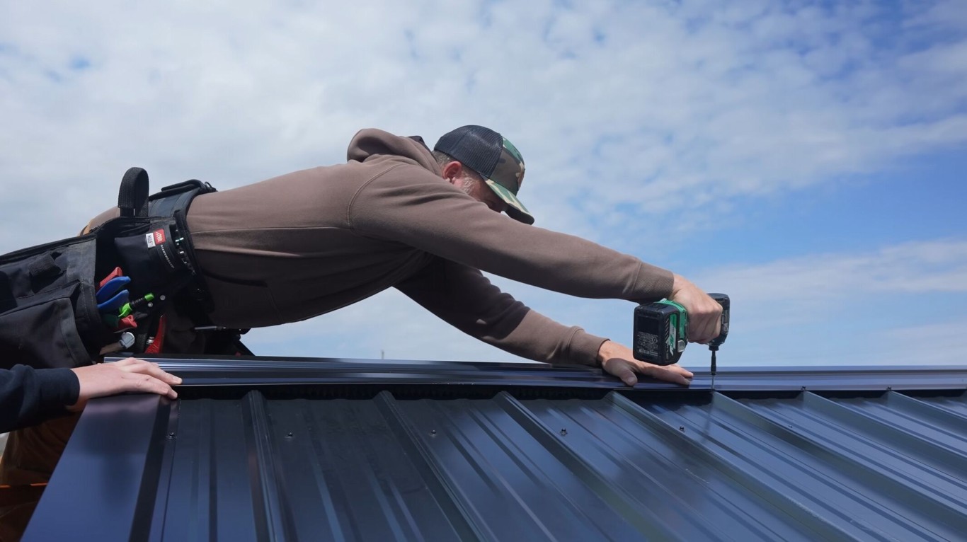 Professional roofing contractor installing metal roof in Los Banos, CA